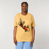 A woman standing, wearing a yellow organic cotton t-shirt with a hand-painted 'Koi Fish' print by fauna.ie