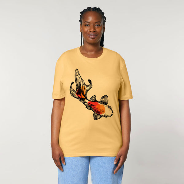 A woman standing, wearing a yellow organic cotton t-shirt with a hand-painted 'Koi Fish' print by fauna.ie
