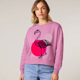Person wearing a pink sweatshirt with a flamingo design by fauna.ie