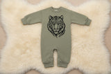 Green baby romper with a tiger design on a white background